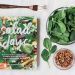 Salad day cookbook beside clear glass bowl with vegetable